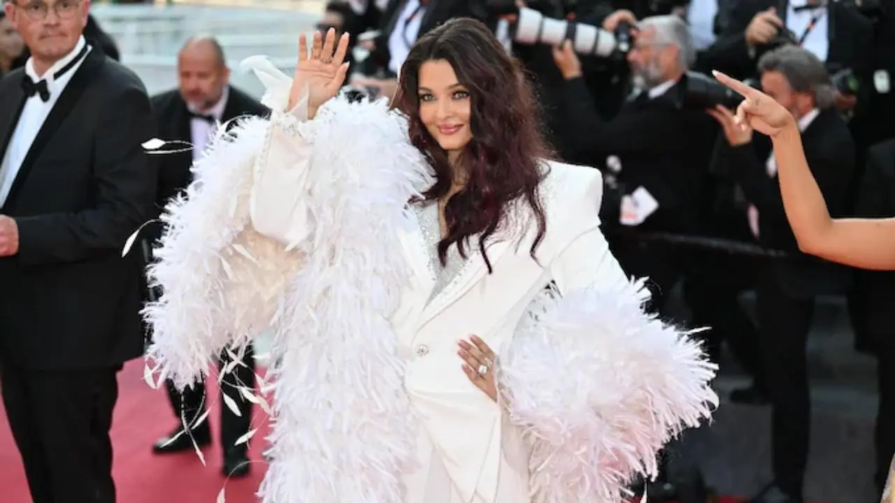 Aishwarya Rai Bachchan turned heads at Cannes 2026’s closing ceremony in a dramatic white pantsuit by Cheney Chan. Featuring feather detailing and sharp tailoring, the look received widespread praise online. Read full story here Aishwarya Rai Bachchan turned heads at Cannes 2026’s closing ceremony in a dramatic white pantsuit by Cheney Chan. Featuring feather detailing and sharp tailoring, the look received widespread praise online. Read full story here